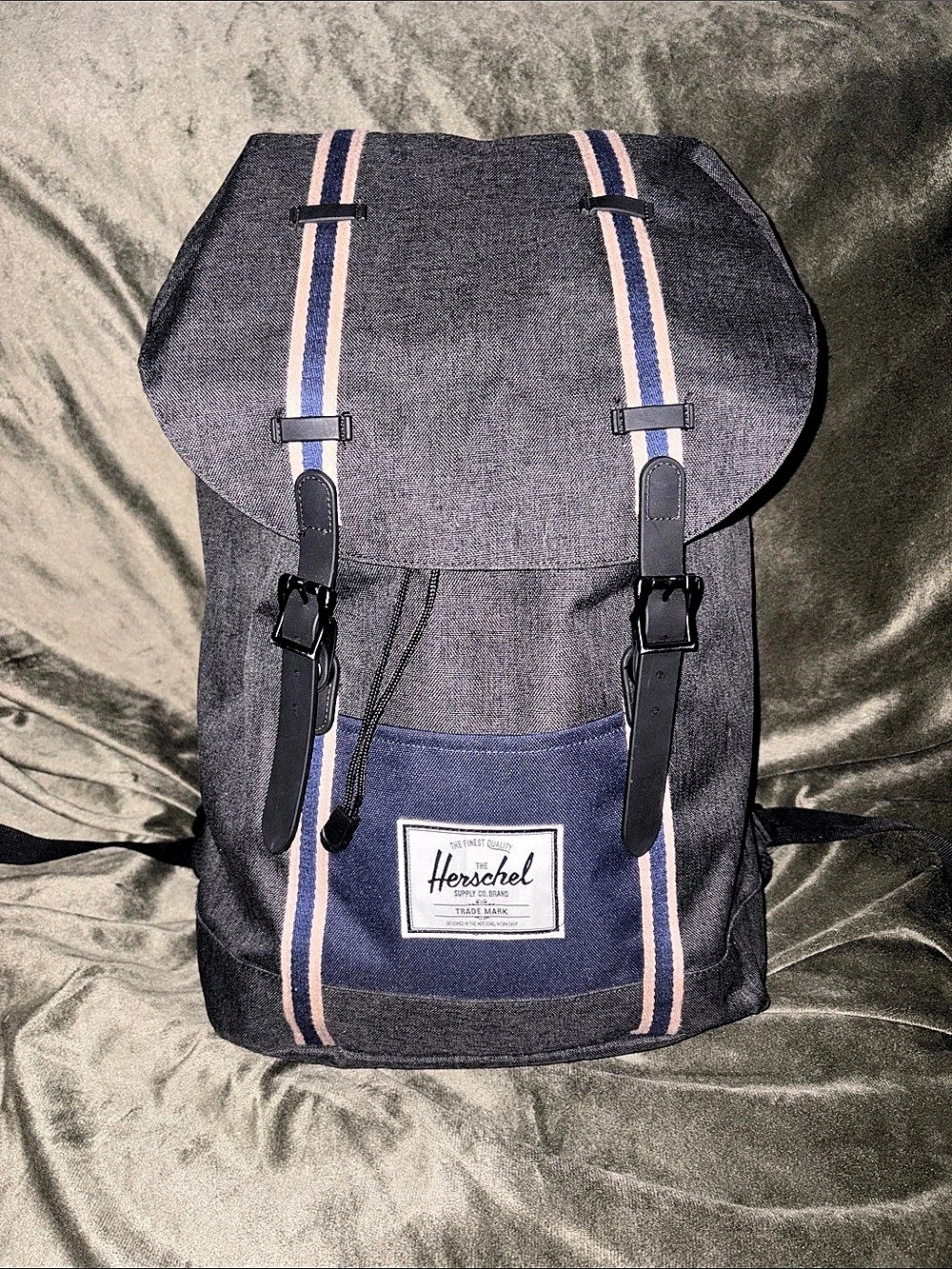 A Herschel Supply Co. Little America grey backpack with blue details.